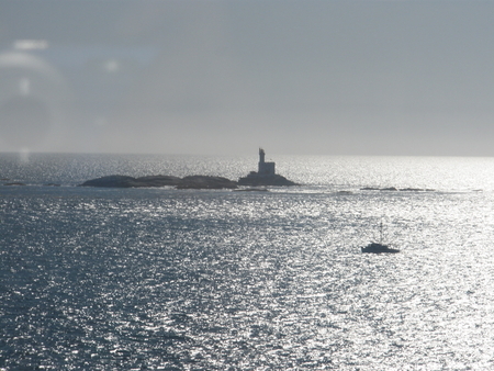 Lighthouse and fishboat in the evening